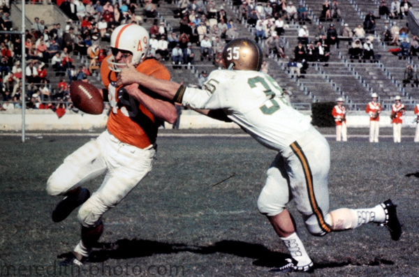 A Texas Longhorn battles for yardage against a defender during a game in 1960.
