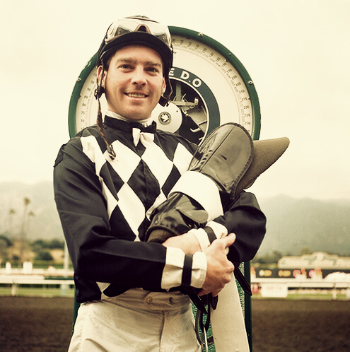 A horse jockey stands on the weight scale for a 1 second portrait after winning a race in Santa Ana, California.  Rolleiflex 75mm f5.6